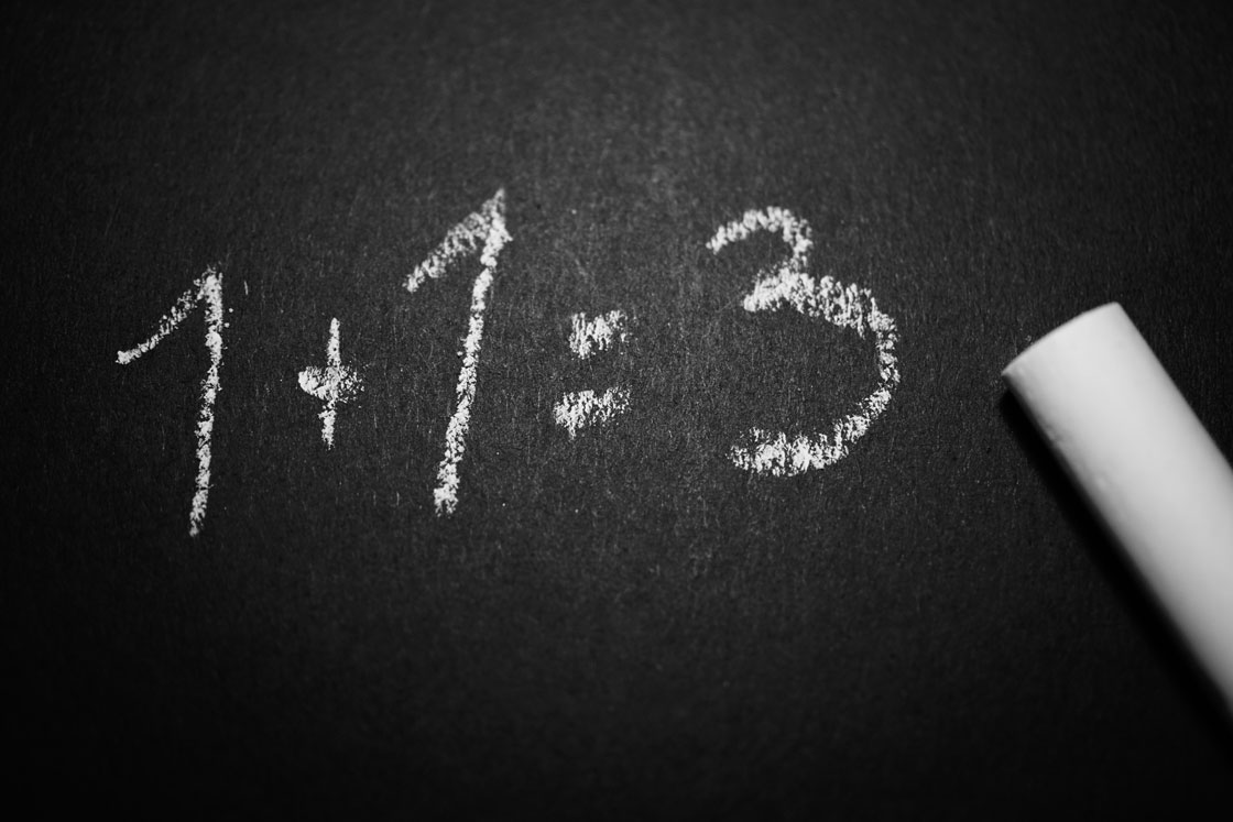 1+1=3 written on black board
