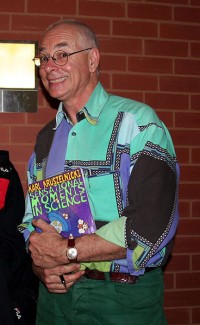 Karl Kruszelnicki holding a copy of his book, Sensational Moments in Science, at Sydney Uni Live! (the University of Sydney's open day) in August 2006. Image by Enoch Lau, via Wikimedia Commons. Used under  Creative Commons Attribution-Share Alike 3.0 Unported license. 